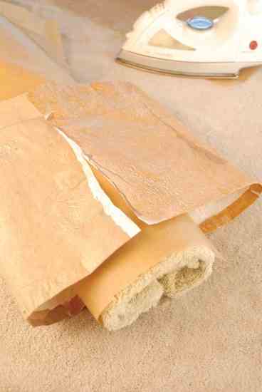 Roll towel and cover with parchment to create a cylindrical ironing surface. Overlap ends of laminated rectangle by 1/2 inch or so to make a seam, then iron to fuse.